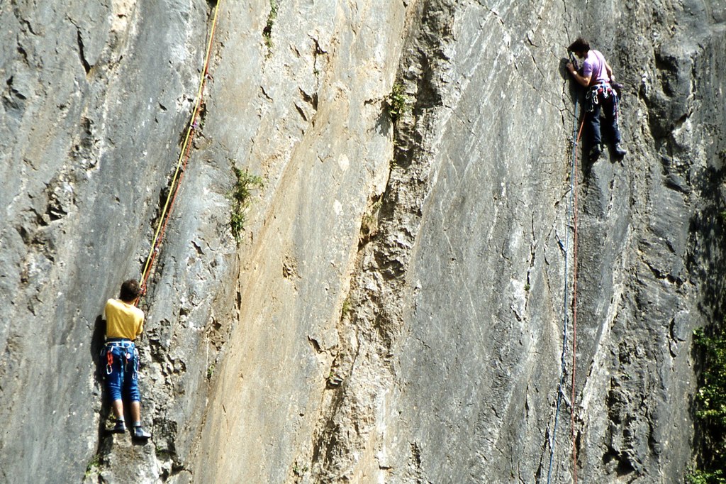 two boys are climbing on Dinas Rock 