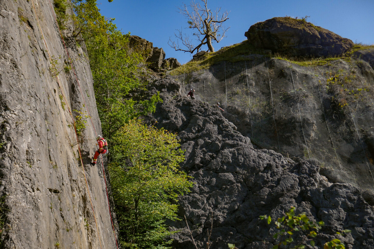 A man is climbing on Dinas Rock 